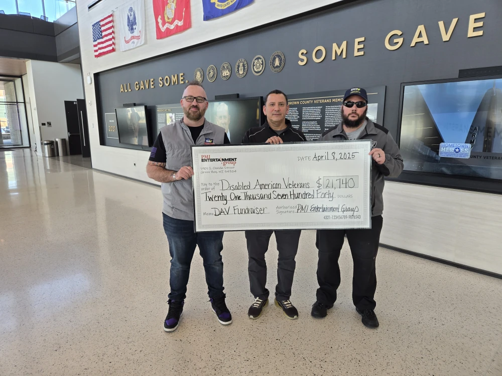 Chapter 3 Commander Daniel Diebold and Adjutant Matt Kempainen receiving a check from the Jersey Raffles at the Bart Starr Plaza Tailgate Party.